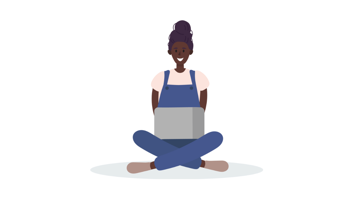 student sitting on ground using laptop